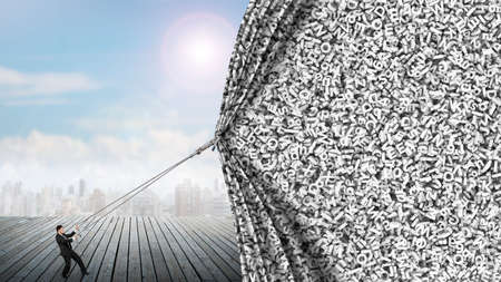 Businessman pulling open gray big data curtain of huge amount letters and numbers texture to cover...