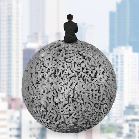 Big data concept. Businessman sitting on gray concrete ball of huge amount 3d letters and numbers, on city buildings skyscraper background.の写真素材