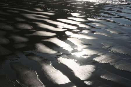 sunshine on water on the beach