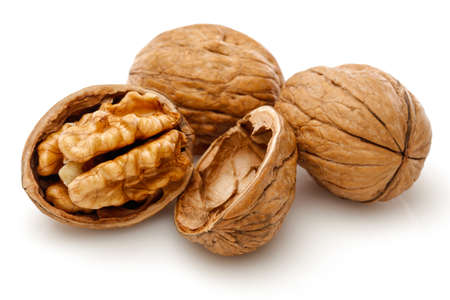 Peeled walnut and its kernels. Isolated on a white backgroundの写真素材