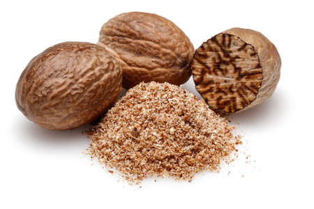 Nutmeg and ground nutmeg on white background.の写真素材