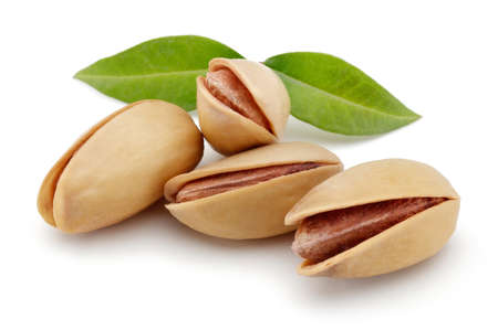 Pistachios nut with leaves isolated on a white backgroundの写真素材