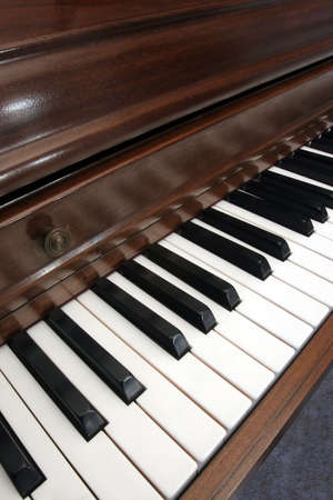 Closeup diagonal of a wooden upright pianoの写真素材