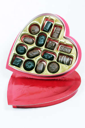 Heart shaped box of chocolates with the candy tilted so you can see it in the box.の写真素材