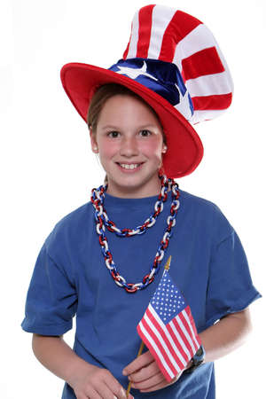 Patriotic young girl with American Flag isolated against a white background.の写真素材