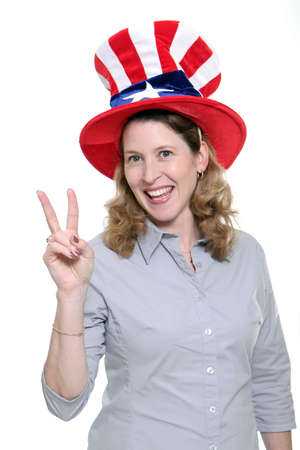 Patriotic woman showing the peace symbol isolated against a white background.の写真素材