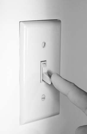 Finger shutting off Light Switch to Conserve Power.の写真素材