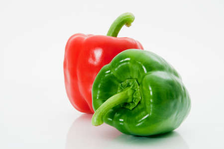 Red and green sweet peppers macro on a white backgroundの写真素材