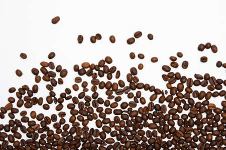 Scattered coffee beans on white backgroundの写真素材