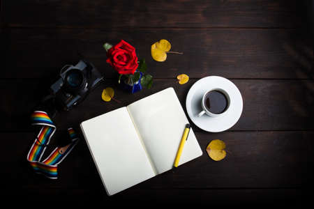 photography top view  retro camera, pen on  blank memory note book and cup coffee on wood background.の写真素材