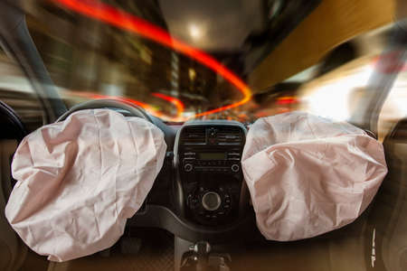 Car of accident make front windshield cracked and airbag explosion damaged at claim the insurance company. Double exposure car accident and cityscape.  Image blur focus  style.の写真素材