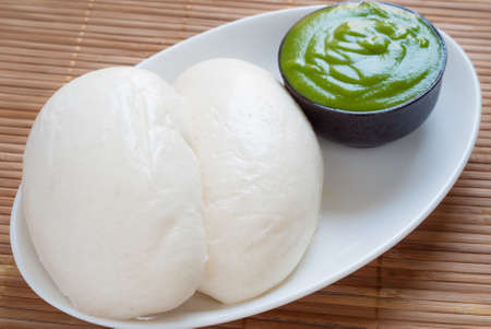 Close up of Mantou (Chinese steamed bun) with Thai pandan custard (Thai style green custard)