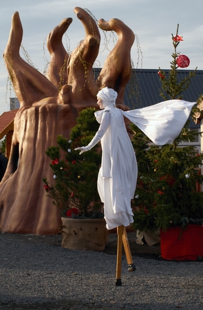 Woman in robe St. Lucia walking on stilts during the celebrations of the feast of Saint Lucia in open air childrenのeditorial素材