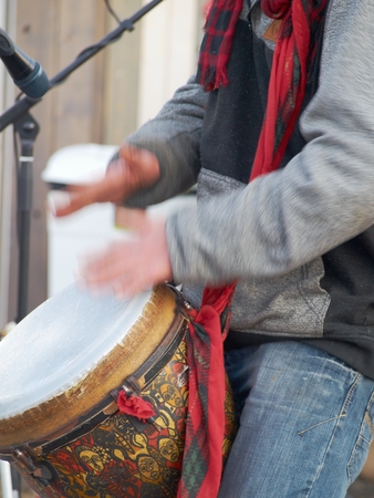 Closeup of male hands playing in the African drum. Motion blur.の写真素材