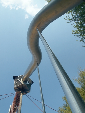 High steel slide on the playground photographed from bottom with blue sky in the backgroundのeditorial素材