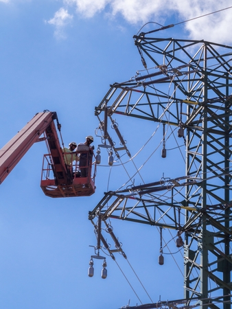 Maintenance with forklift platform on high voltage lines.のeditorial素材