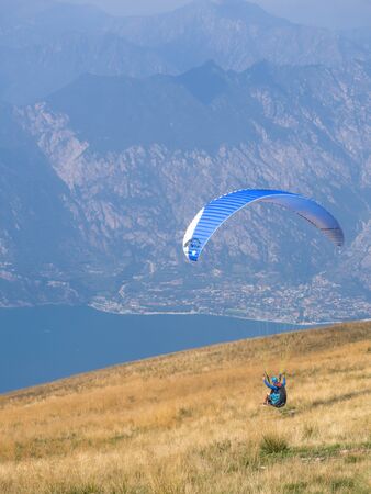 MALCESINE, ITALY â AUGUST 27  2019: Tandem paragliding on Monte Baldo above Lake Garda in the Garda Mountains in the Eastern Alps.のeditorial素材