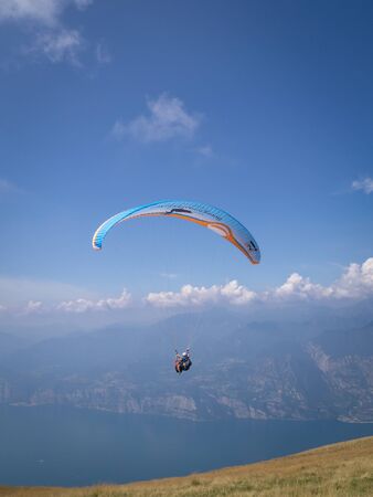 MALCESINE, ITALY â AUGUST 27  2019: Tandem paragliding on Monte Baldo above Lake Garda in the Garda Mountains in the Eastern Alps.のeditorial素材
