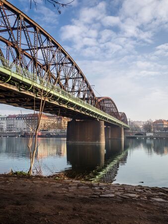 Old railway bridge over the Vltava river in Pragueの写真素材