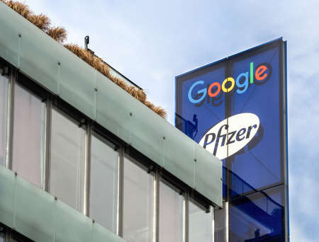 PRAGUE - FEBRUARY 26, 2020: Logo of Google and Pfizer on office building on Stroupeznikeho street in Smichov quarter.のeditorial素材