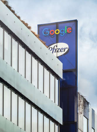 PRAGUE - FEBRUARY 26, 2020: Logo of Google and Pfizer on office building on Stroupeznikeho street in Smichov quarter.のeditorial素材