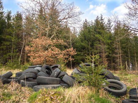 ZVANOVICE, CZECH REPUBLIC â APRIL 4: Illegal tire dump at the edge of the forestの写真素材
