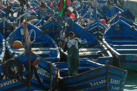 Morocco. Essaouira. A fisherman in a typical blue fishing boats moored at the portのeditorial素材