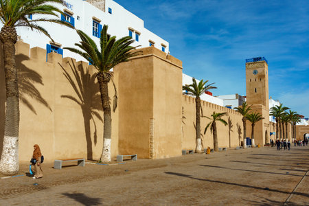 Morocco. Essaouira. People walking along the ramparts and the clock towerのeditorial素材