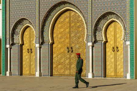 Morocco. Fez. A soldier of the royal guard in front the royal palace founded by the Merinids in 1320. It opens onto the Place des Alaouites through huge doors chiseled in copper made by a local craftsman around 1970.のeditorial素材