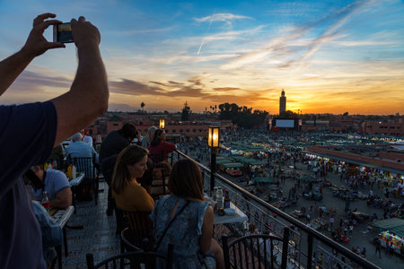 North Africa. Morocco. Marrakesh. People taking photo at Place Jemaa el fna at sunsetのeditorial素材