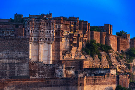 India. State of Rajasthan. Jodhpur. Mehrangarh Fort (historic stronghold of the Rathore Rajput royal rulers). Outer walls and ramparts, colonnaded walkways in a golden late afternoon lightの写真素材