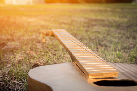 Acoustic guitar on the grass summerの写真素材