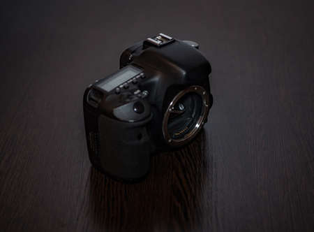 A digital SLR camera lies on a tableの写真素材