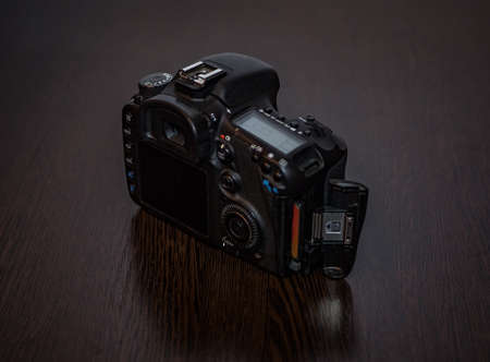A digital SLR camera lies on a table