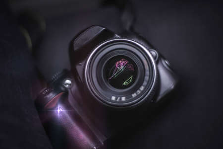 A digital SLR camera lies on a tableの写真素材