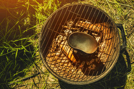Soup to be cooked in a pot on the fire in a hikeの写真素材