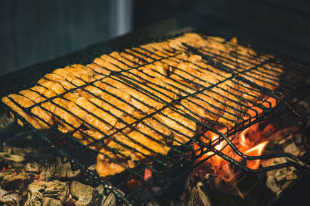 The meat is fried on the grill on an open fireの写真素材