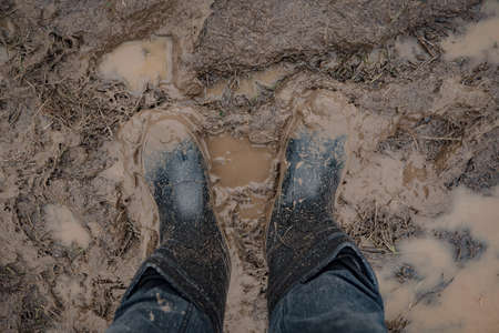 In rubber boots on dirt, at the festivalの写真素材