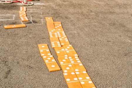 Large wooden dominoes on the asphalt on a summer dayの写真素材