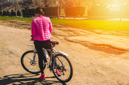 Girl on a bicycle in a summer sunny dayの写真素材