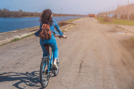 Girl on a bicycle in a summer sunny dayの写真素材