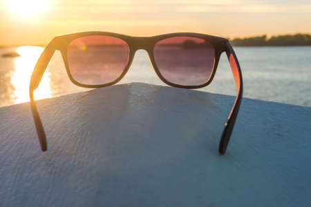 Sunglasses on the beach, bright summer dayの写真素材