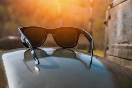 Sunglasses in an old military car, spring dayの写真素材