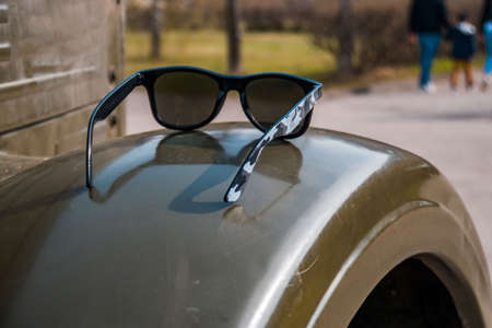 Sunglasses in an old military car, spring dayの写真素材