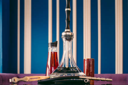 A beautiful glass hookah in a cafe on the table