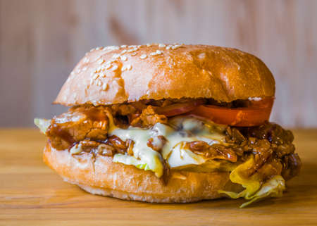 Delicious and juicy burger with appetizing meatball and fresh vegetablesの写真素材