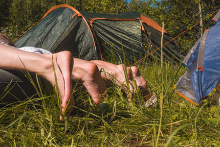 One guy and two girls are lying on an inflatable mattress