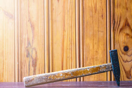 A hammer with a wooden handle on the background of boards. Work toolの写真素材