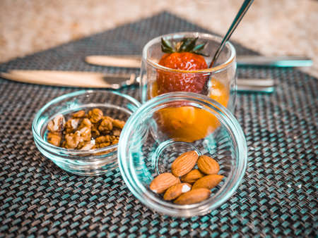 Nuts and strawberries in glass bowls. delicious snacks for breakfast in the hotel restaurantの写真素材