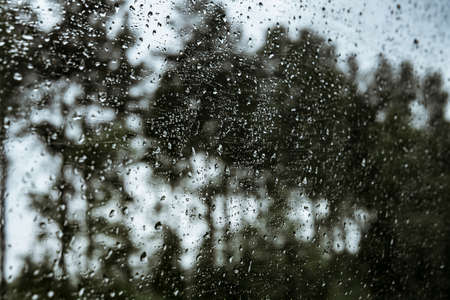 Drops on the glass on the train. On a long trip heavy rain
